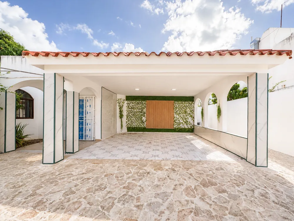 The covered carport and the arched front entrance