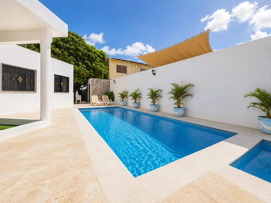 The pool from the terrace, shade sail at the far end