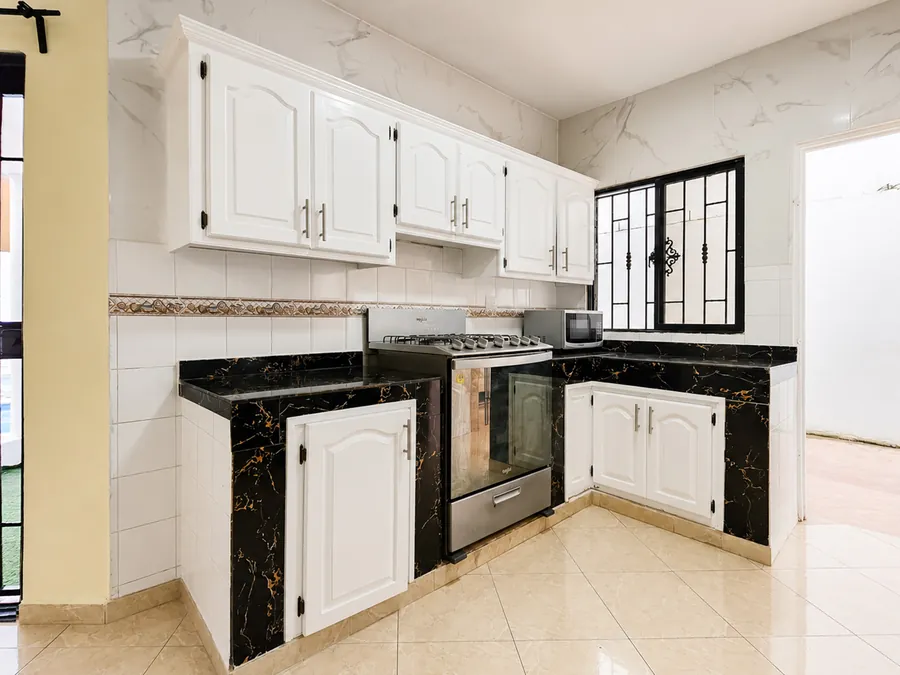 Gas hob, oven, and black marble counters